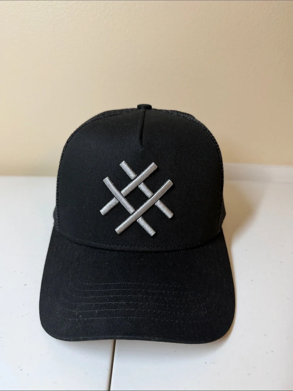 Lucid FC Black Trucker Hat with Silver Embroidered Geometric Logo, Rihanna style